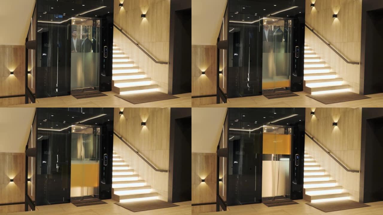 一群商人正在现代玻璃电梯中前进。成功人士乘电梯到商务中心的顶部。时尚的男人和女人在谈论电梯内部的项目