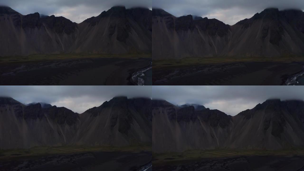 无人机在黑沙滩上朝着Vestrahorn