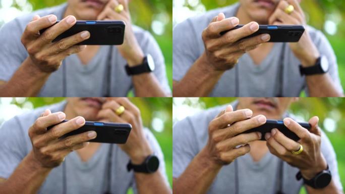 使用智能手机在线交流的男人的手的特写镜头。