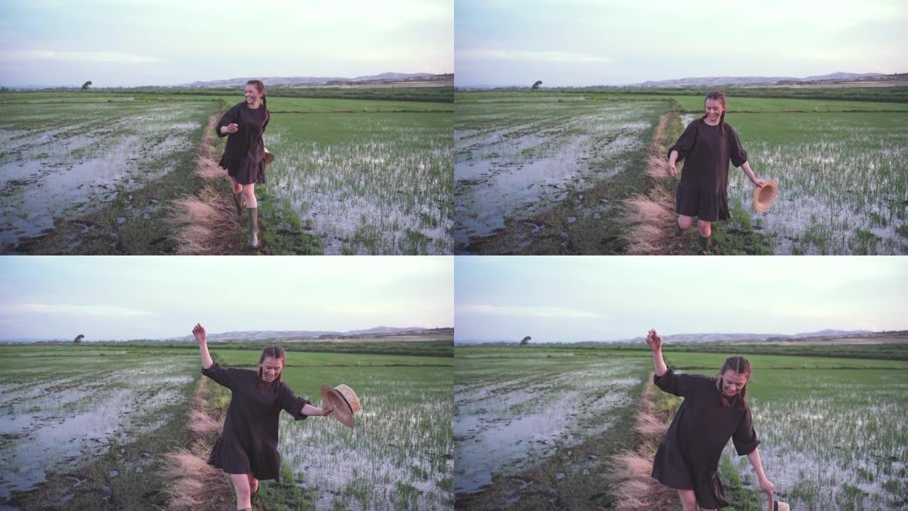 农场女孩在稻田上奔跑，脸上带着米杯