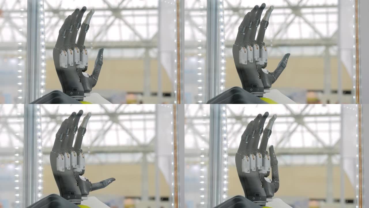 慢动作: 电子黑色假肢人类手臂移动个人手指