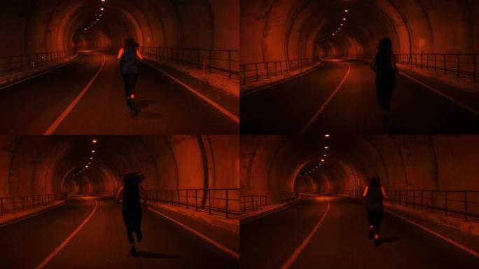 沿着隧道跑的年轻女子。女运动员在隧道里跑得很快。运动动机。积极的运动生活方式。户外慢跑训练