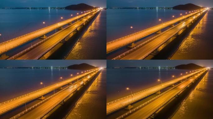 空中无人机在穿越宋卡湖，Tinsulanonda大桥的桥上的交通汽车的昼夜场景。泰国宋卡跨湖大桥沿线