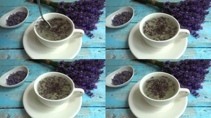 复古木制背景上的淡紫色鲜花茶。茶是在杯子里用热水冲泡的。慢动作。