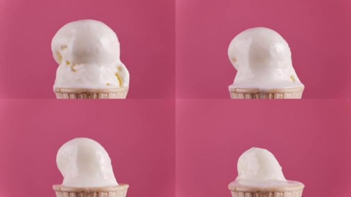 香草冰淇淋融化在粉红色背景上。冰淇淋融化的延时。