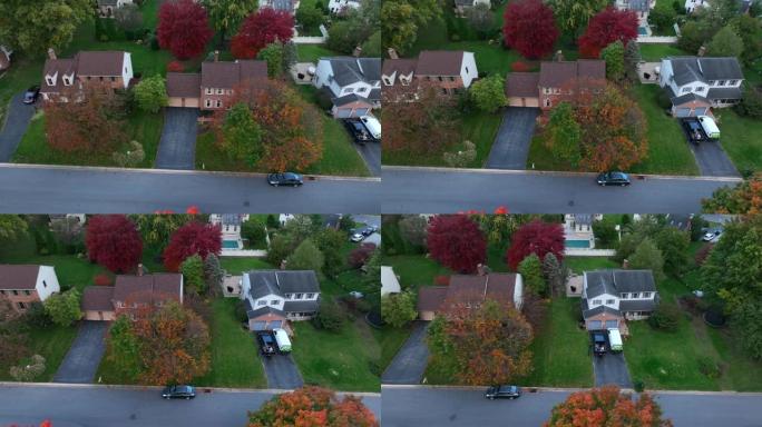 美国附近的房子。傍晚时分的秋天树木。空中卡车射击。