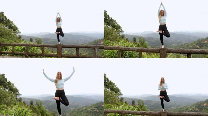 年轻的旅游瑜伽女子可以从山上高处的木桥欣赏风景，该木桥设计用于从上方观看侧面。在丛林里。山的生动形象