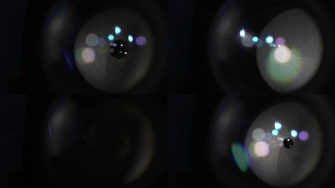 相机镜头光学玻璃上的圆形彩色信号弹。开口光圈叶片的宏观拍摄