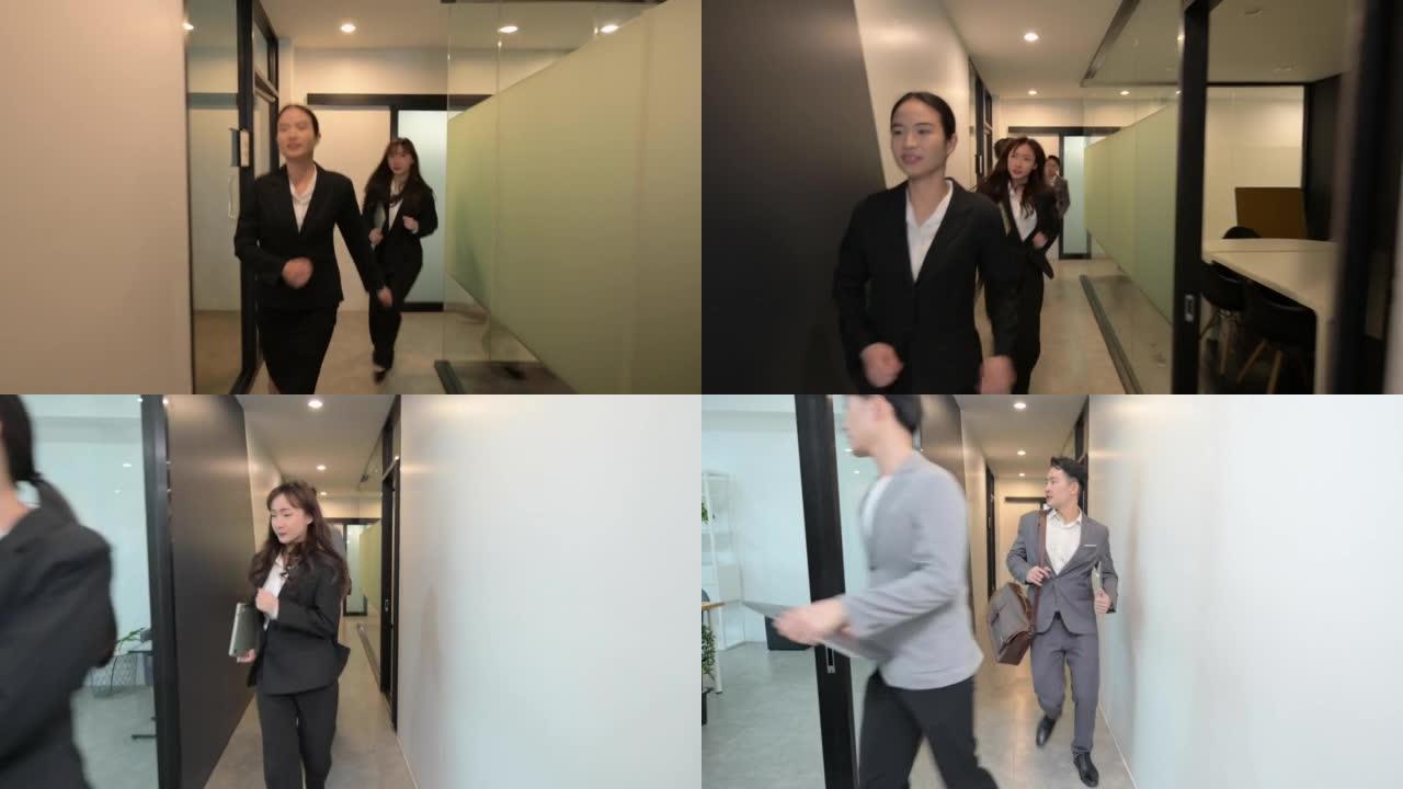 一群年轻的亚洲商界人士奔跑走出办公室，防火逃生概念
