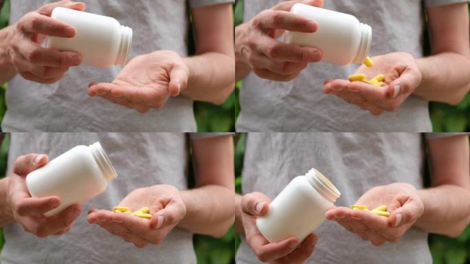 一名男子将白色塑料瓶中的黄色药丸倒入手中的特写镜头。慢动作。