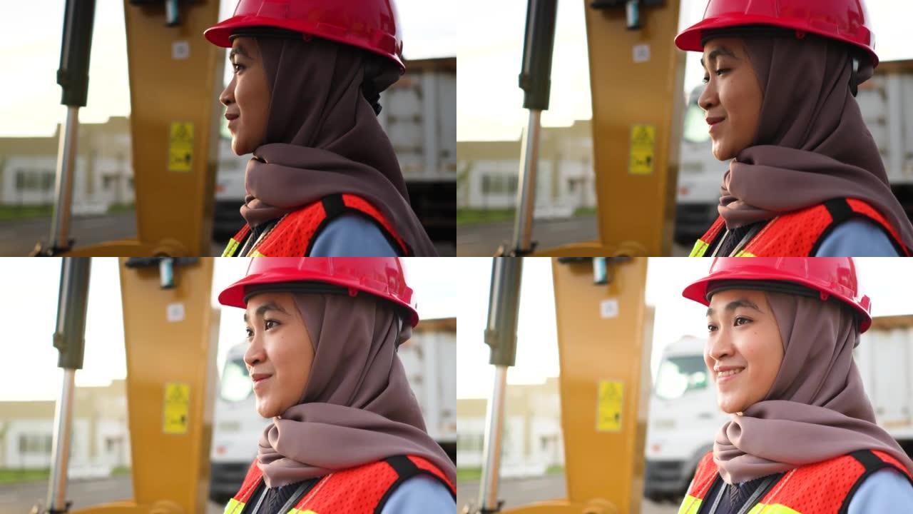 在工厂大楼工作的工程师穆斯林妇女