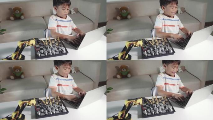 亚洲小男孩编程代码机器人机器手臂上的笔记本电脑下棋