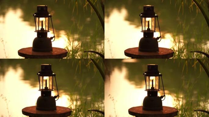 老式油灯晚上在森林里河边，露营概念。软焦点。