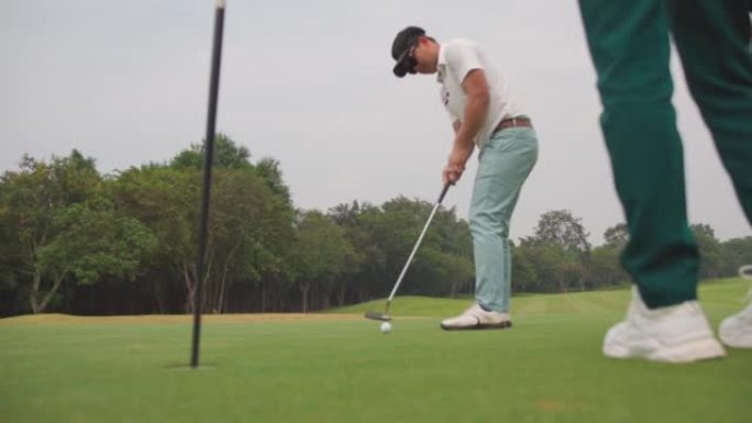 4k亚洲男子高尔夫球将高尔夫球通过球道上的一个洞