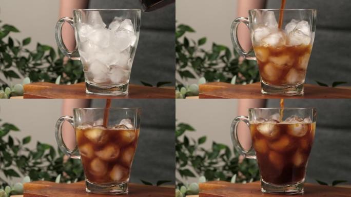 4k视频，将冲泡咖啡倒入装满冰的玻璃杯中，并在木桌上放饼干。慢动作制作冷咖啡饮料。
