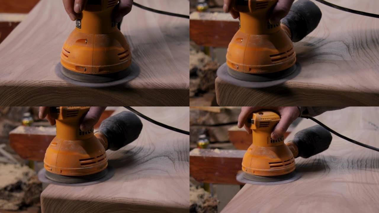 车间用轨道砂光机打磨木桌的木匠特写