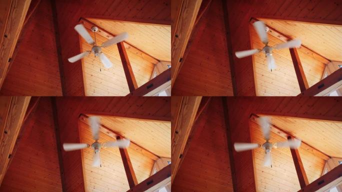木制天花板。吊灯风扇在运行。吊灯风扇在天花板上运行。风扇吊灯