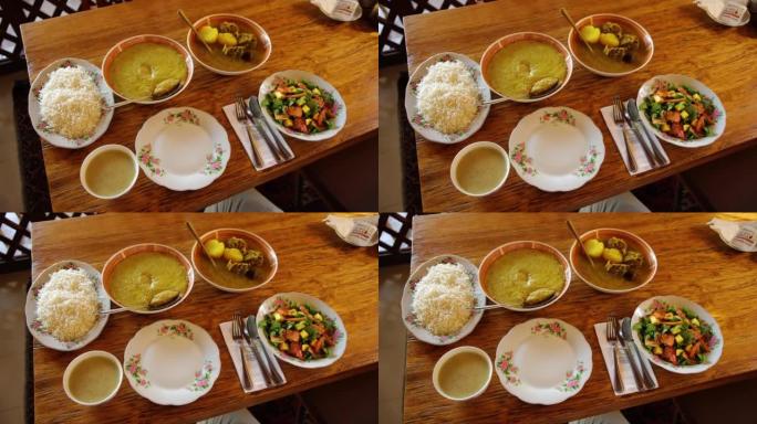 桌上的一套菜肴-米饭，沙拉，炖汤，乡村亚洲或阿拉伯。