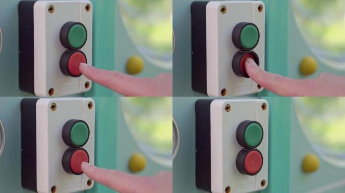 操作员的手按下控制面板上的红色关闭按钮