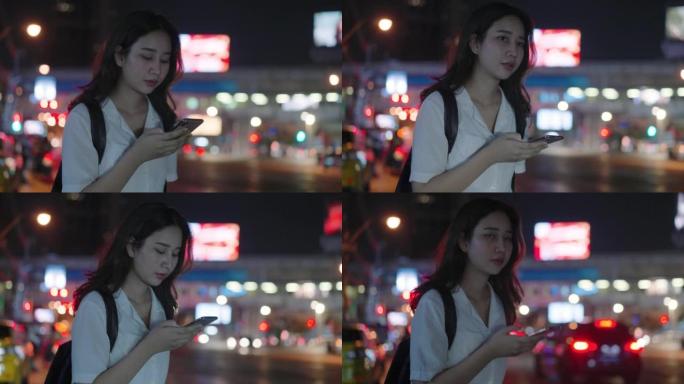亚洲女性晚上用智能手机叫出租车