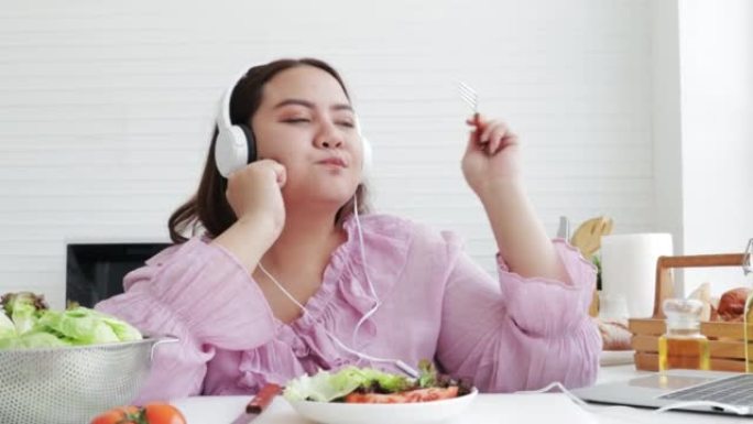 亚洲超重女人吃新鲜沙拉。减肥和健康理念。食品