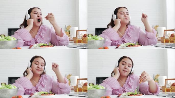 亚洲超重女人吃新鲜沙拉。减肥和健康理念。食品