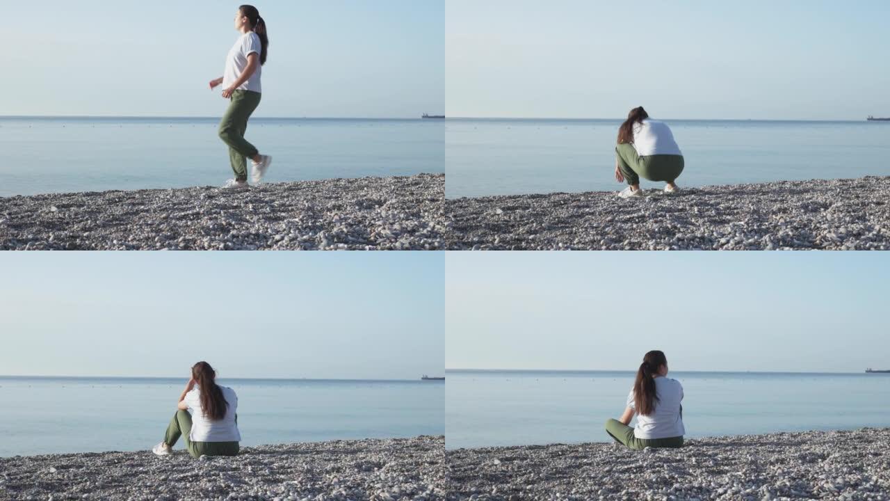 年轻女子早上在海边慢跑以保持体形后休息