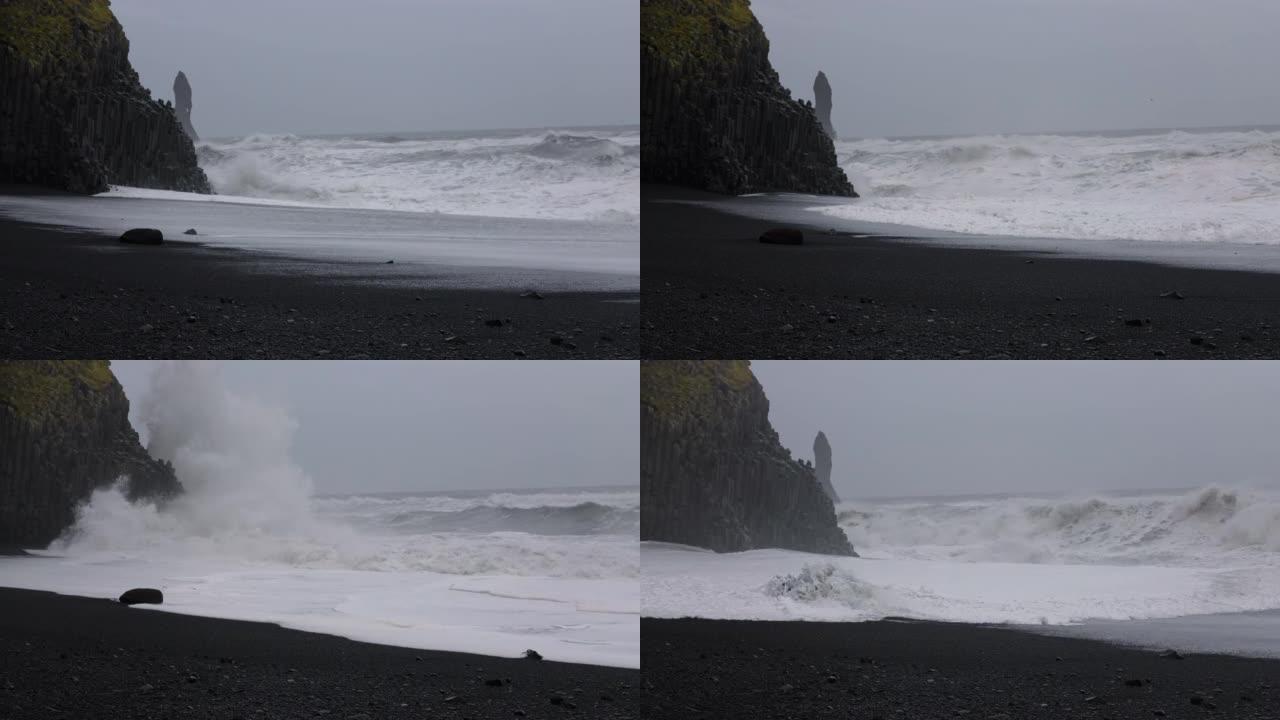 黑沙滩上的海浪撞击岩石
