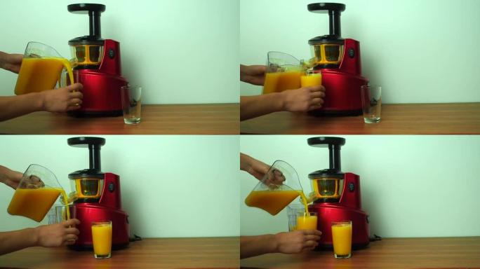 螺旋钻榨汁机螺旋制作橙子蔬菜汁。