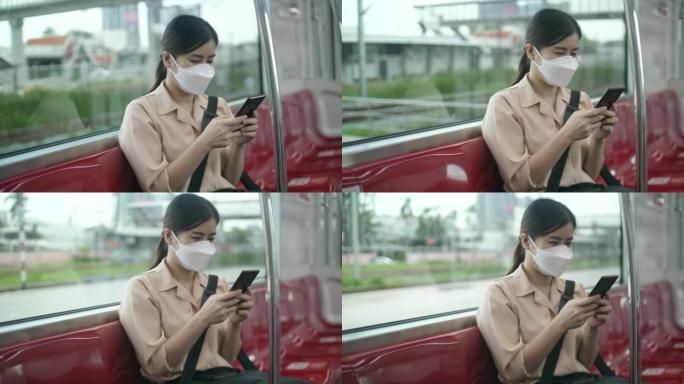 年轻女子在火车上使用电话和短信