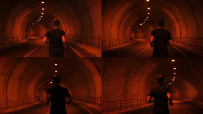 跟随男子运动员在高山山脉的隧道中奔跑的镜头。男跑步者在户外锻炼，做有氧运动训练。健身娱乐活动。运动概