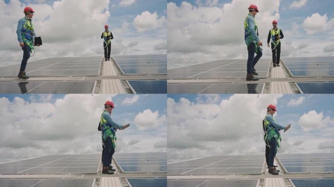 夫妇工程师检查在阳光下在屋顶上安装太阳能电池板。可再生能源的概念。