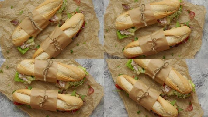 美味的自制三明治法式长棍面包，搭配各种健康食材。早餐带走概念