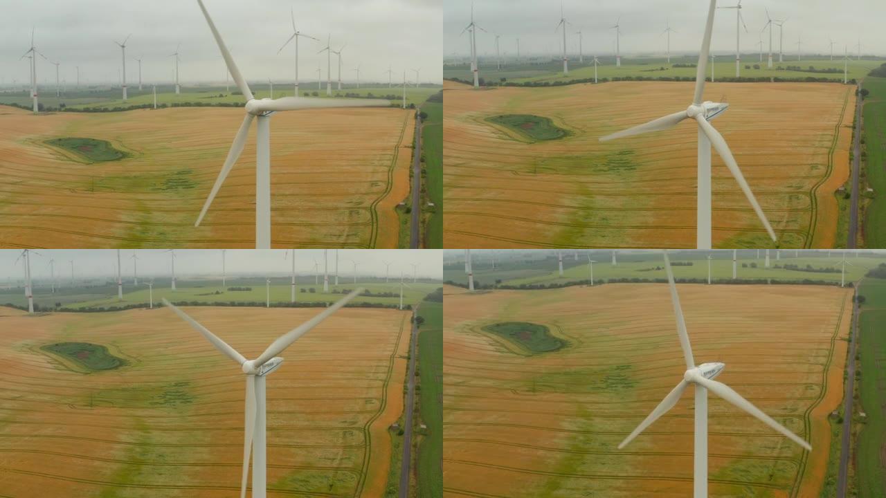 风力涡轮机旋转转子的高镜头。风电场以可再生能源为背景。绿色能源、生态和减少碳足迹概念
