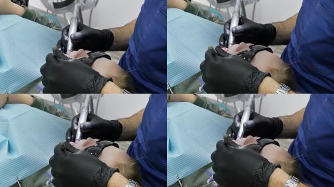 牙医戴着黑色手套的手的特写镜头可以治疗女孩躺在椅子上的牙齿，并在她的眼睛上戴上墨镜，以防灯的光。慢动