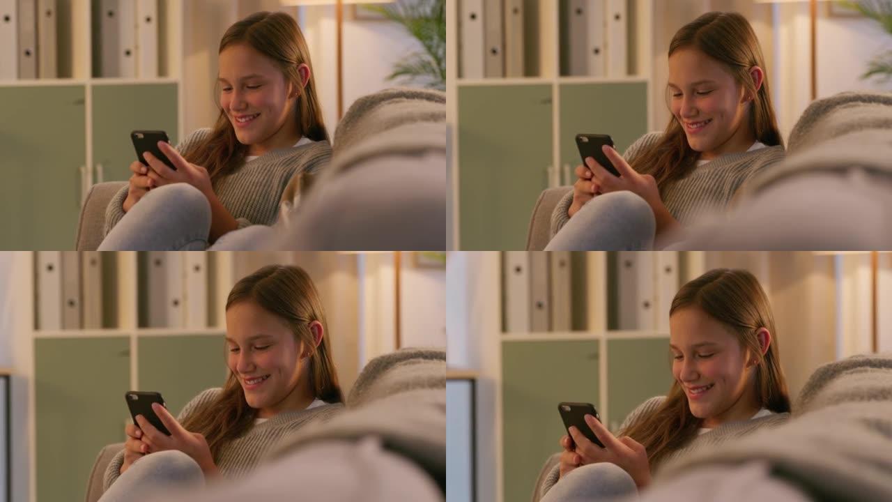 十几岁的女孩上网，看着她的手机屏幕。微笑的女孩浏览社交媒体，在手机上发送短信。小女孩在沙发上的智能手