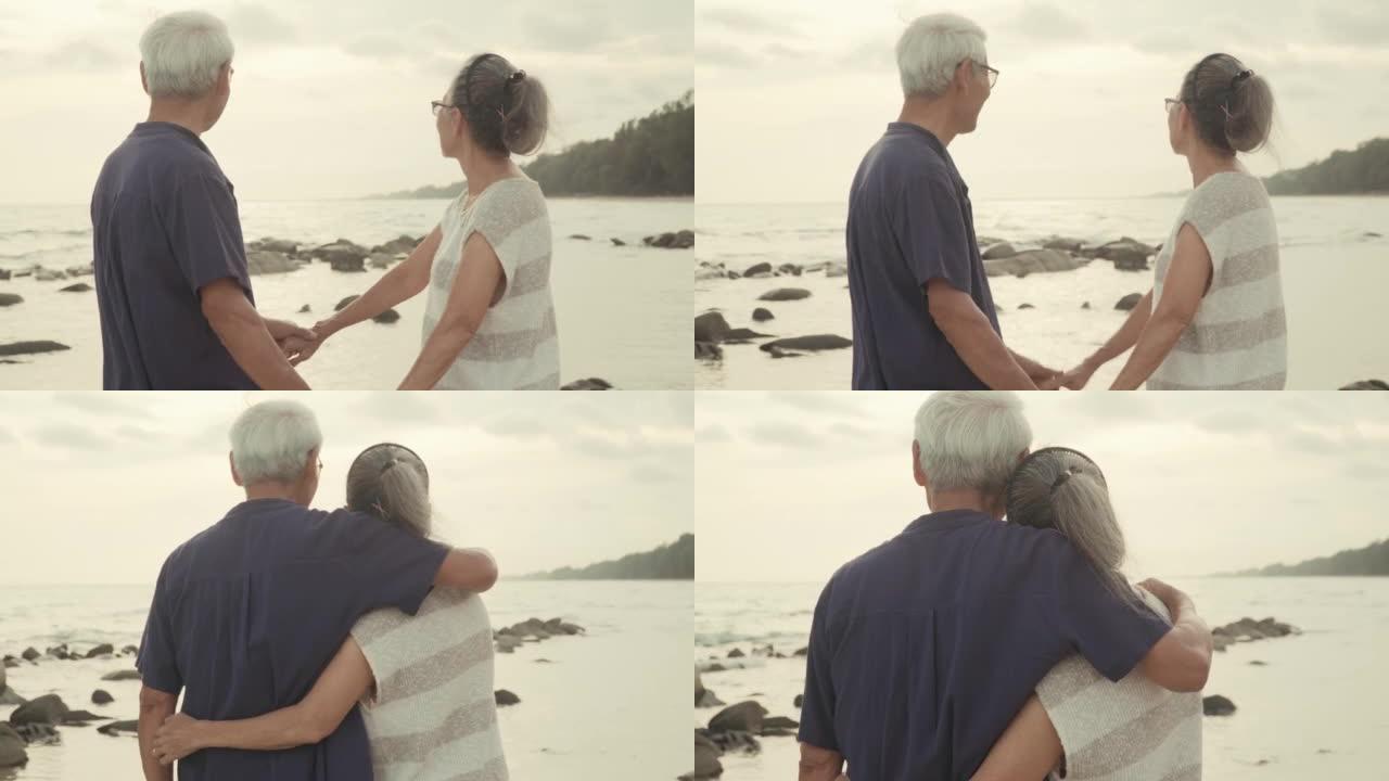 亚洲老年夫妇在海滩上享受浪漫假期