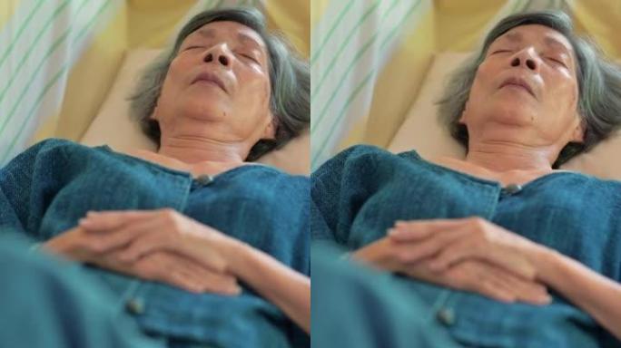 Asian senior woman feeling sick and taking a nap