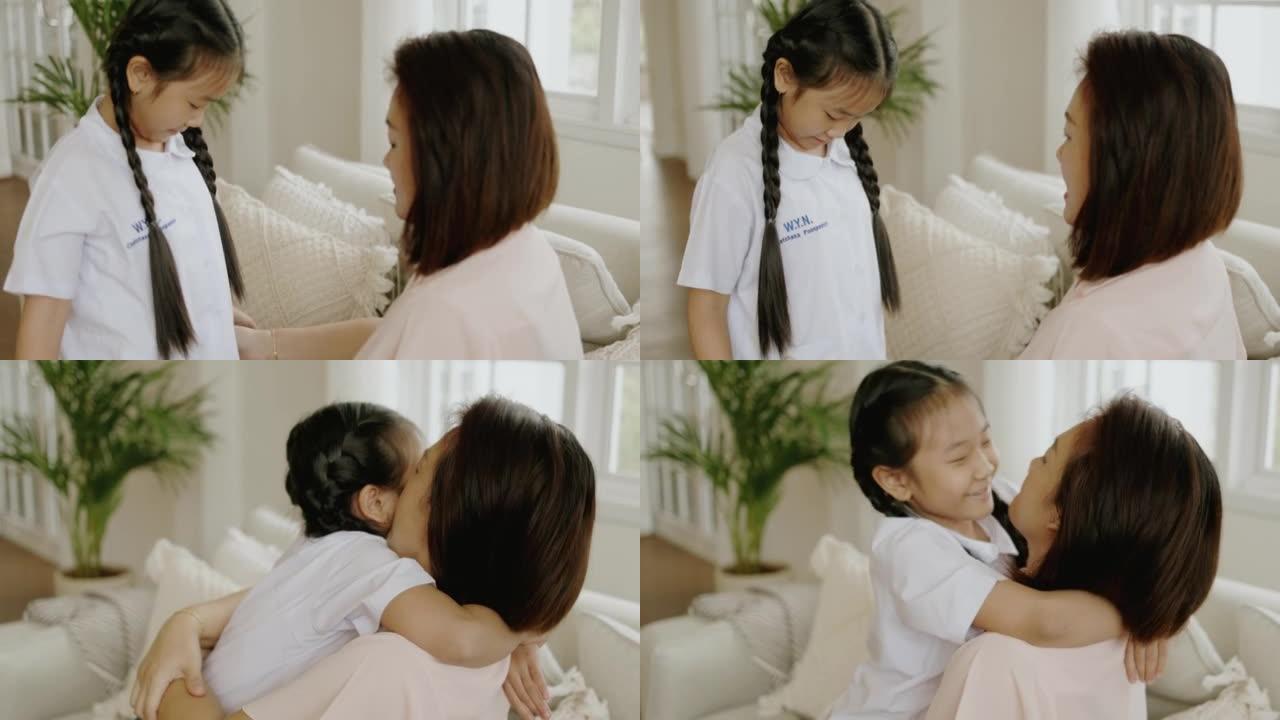 泰国女孩上学第一天前的大拥抱。