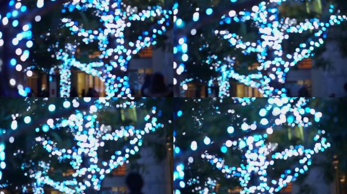 六本木日本东京地区蓝色神奇圣诞照明灯模糊拍摄人们行走冬天