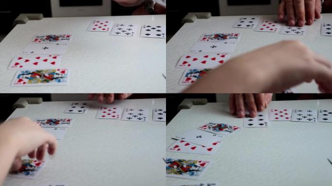 4k视频，爷爷和孙子的手打牌特写，教一个孩子打牌，一起度过时光