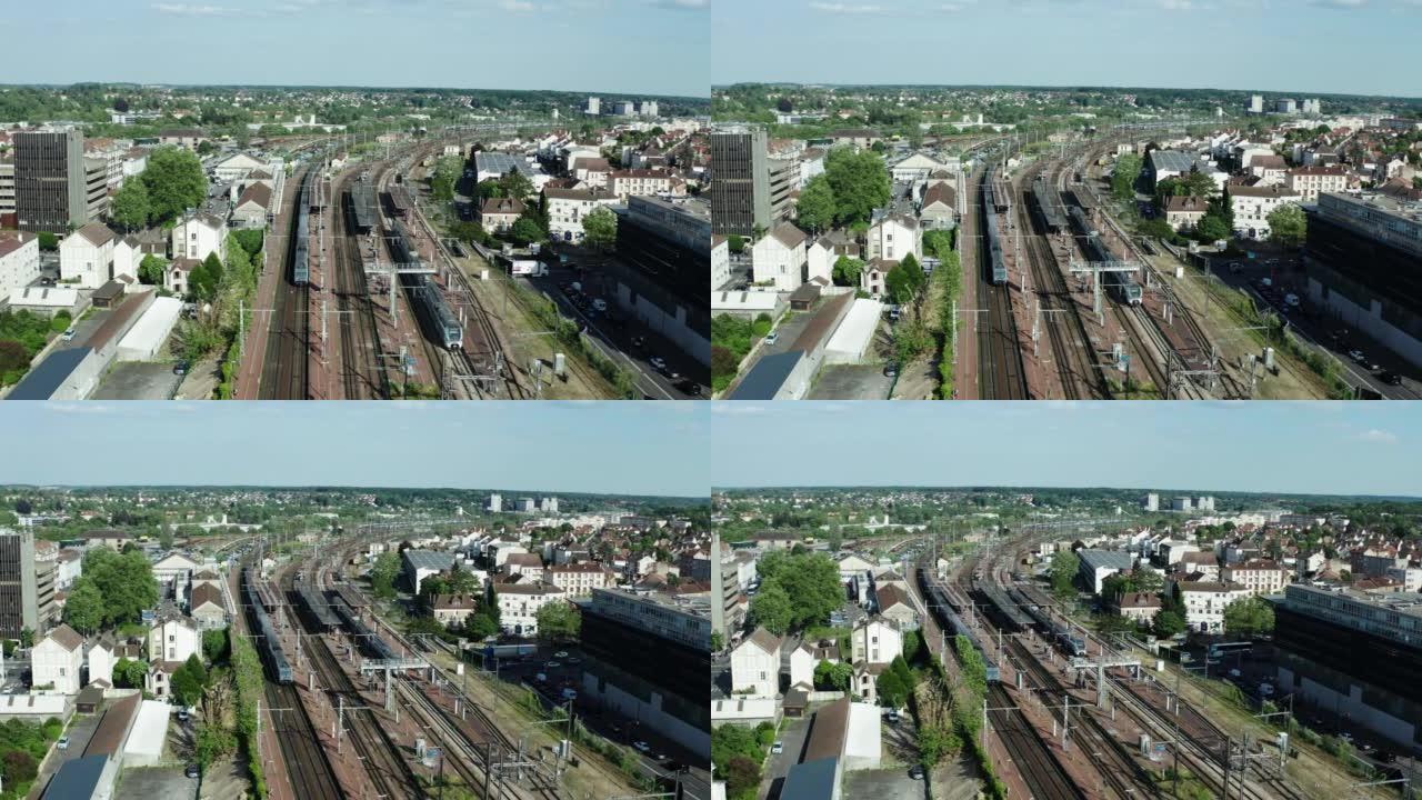 城市火车站铁路路线无人机视图。旅客列车到达车站。宽航拍镜头