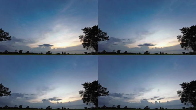 乡村地平线上日落的彩色快速时间圈是4K。太阳4k照亮的日落云的时间流逝。透过云层的光线和刺眼的阳光。