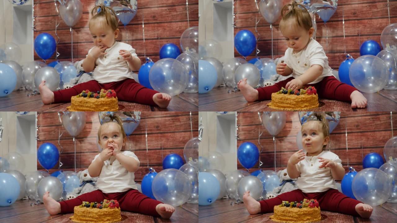 沾满食物的婴儿脸用手指吃一个甜蜜的生日蛋糕在地板上，浆果顶部庆祝1年