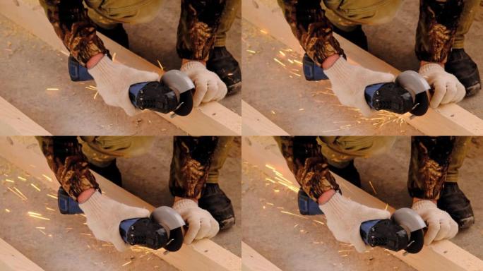 一名建筑商的双手戴着工作手套，用角磨机电动工具切割金属发夹。准备木地板的原木。亲手上门修理，锯木厂。
