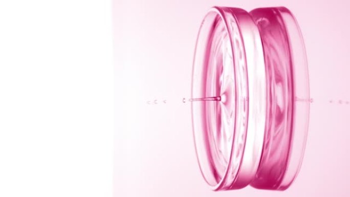 粉红滴落入培养皿中，液体产生涟漪