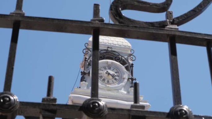 Low Angle View Of Vintage Clock Tower Behind Fence