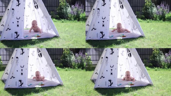 阳光明媚的日子里，小婴儿躺在花园的白色帐篷里