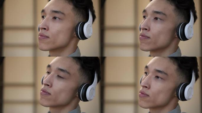 亚洲帅哥喜欢戴着耳机听音乐