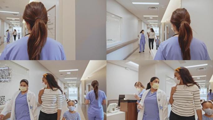 女儿科医生在医院走廊与患者的妈妈交谈